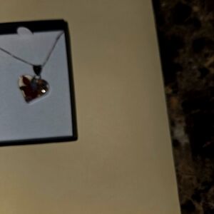 Heart shaped pendant with real flowers.